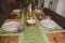 100% Cotton green table runner on the dinning table with glasses and dishes