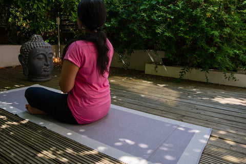 A young women doing yoga on cotton yoga mat  